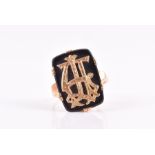 An 18ct yellow gold and onyx ring with applied gold initials to onyx plaque, possibly TH, size N,