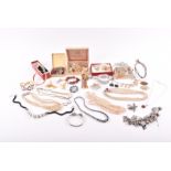 A quantity of assorted costume jewellery to include various beaded necklaces, costume brooches,