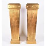 A pair of large gilded marble topped hall pedestals  of tapering fluted column form on stepped