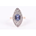 A rose gold, diamond, and blue stone navette ring centred with an emerald-cut synthetic sapphire,