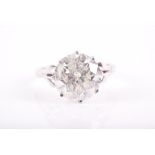 A large solitaire diamond ring set with a round brilliant-cut diamond of approximately 6.10