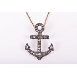 An 18ct yellow gold, silver, and diamond anchor pendant set with mixed rose-cut diamonds, mounted in