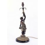 A French patinated bronze Oriental figural lamp modelled as a man dressed in draped clothing and a