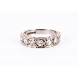 An 18 carat white gold diamond half eternity ring   set with seven round brilliant-cut diamonds of