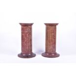 A pair of simulated marble effect wooden column pedestals designed with stop fluted circular