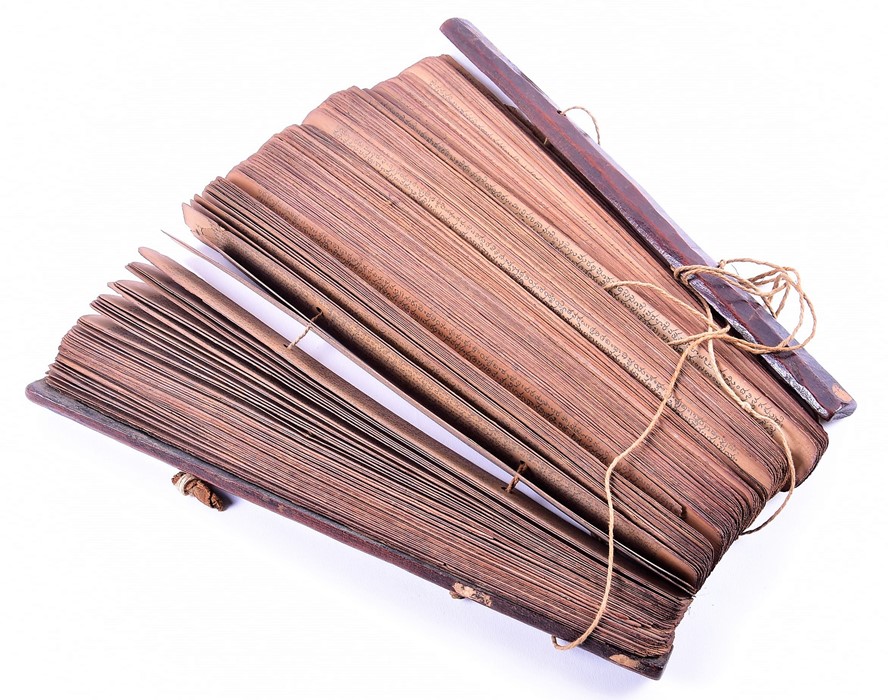 An antique South East Asian Buddhist prayer manuscript hand written calligraphy on palm leaves, with