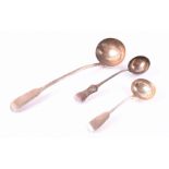 Three silver ladles to include one large 19th century English soup ladle with family crest detail,