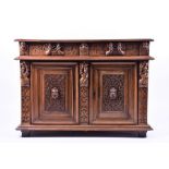A 19th century Continental carved oak cupboard  with two drawers over two cupboard doors, the