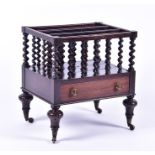 A Victorian rosewood three division Canterbury with twin handled front drawer and twist turned bars,