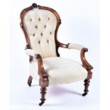 A Victorian mahogany show wood frame armchair  with cream button back upholstery, on turned front