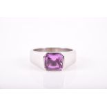 An 18ct white gold and pink sapphire ring set with a rectangular cushion-cut natural pink Madagascan
