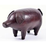A brown leather footstool modelled as a pig in the manner of Dimitri Omersa for Liberty (