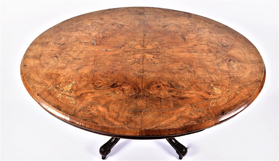 A late Victorian walnut and inlaid oval loo table  with quarter-veneered top, the matched base on - Image 2 of 5