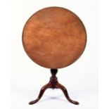 A Victorian mahogany tilt top table on a tripod base, 69 cm high x 67 cm diameter.
