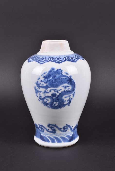 A Chinese Kangxi period blue and white baluster jar the body decorated with three roundels depicting