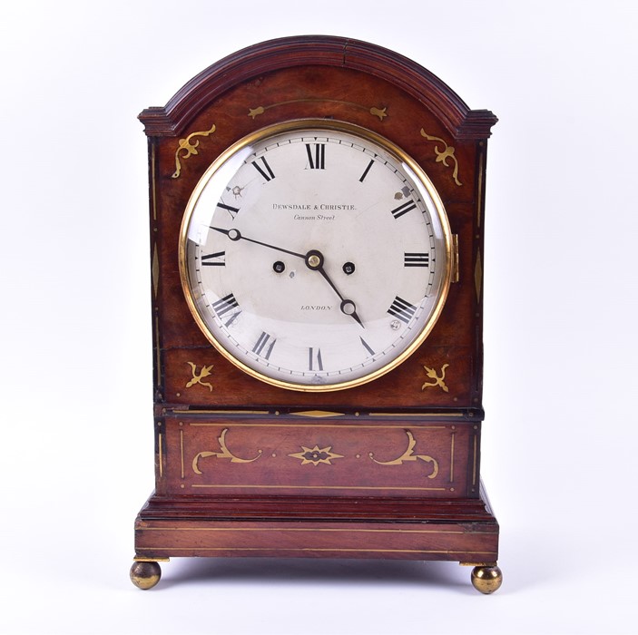 A Regency mahogany and brass inlaid bracket clock with arched top, eight day movement striking on