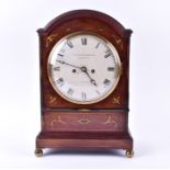 A Regency mahogany and brass inlaid bracket clock with arched top, eight day movement striking on