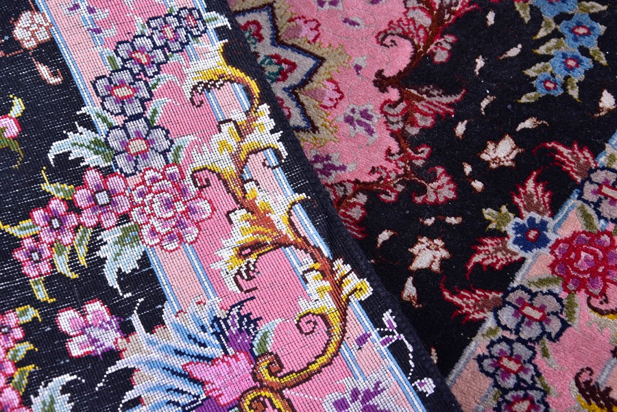 A near pair of small Iranian rugs with fringed ends, each with central black field designed with - Image 5 of 5