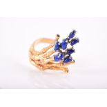 A Continental yellow gold and lapis lazuli ring of abstract design, the mount in the form of a spray
