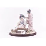 A Lladro porcelain figure group: 'Springtime in Japan' model No. 1445, on conforming wooden base, 33