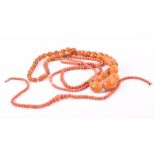 A group of three coral beaded necklaces two with yellow metal clasps, one lacking clasp, and amber