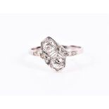 A diamond set crossover-style ring set with two old-cut diamonds, each within a hexagonal mount, the