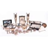 A group of assorted silver items including a pair of slender spill vases, a sauce boat, two