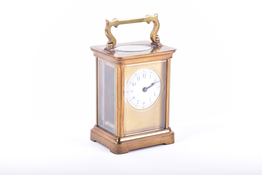 A brass bound Carriage clock with engraved inscription and enameled dial. - Image 3 of 4
