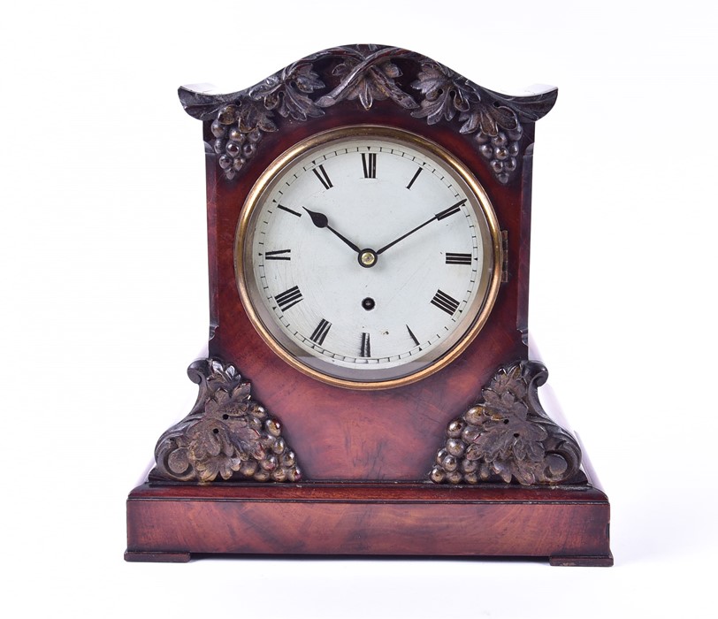 A Victorian mantel timepiece in a rosewood case with relief moulded vine and grape decoration, the