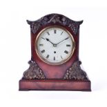 A Victorian mantel timepiece in a rosewood case with relief moulded vine and grape decoration, the