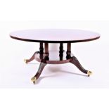 A reproduction mahogany circular coffee table the top supported on four columns, united by under-