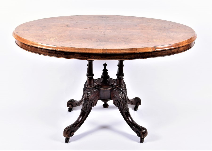 A late Victorian walnut and inlaid oval loo table  with quarter-veneered top, the matched base on