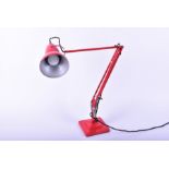 A Herbert Terry angle poise table lamp with red painted finish.