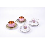 A pair of Imperial Russian Kuznetsov porcelain cups and saucers the cups modelled as blooming