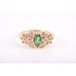 An 18ct gold, diamond, and emerald ring centred with a marquise-cut emerald, the shoulders