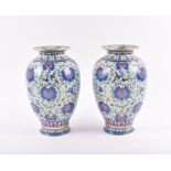 A pair of early 20th century Chinese cloisonne vases decorated with flowers amongst spiralling
