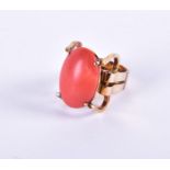 A coral ring by "Larry" of Hong Kong, the deep salmon pink oval cabochon coral measuring 21 x