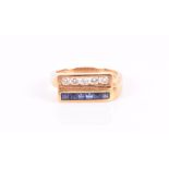 An 18ct yellow gold, diamond, and sapphire ring channel-set with a line of round-cut diamonds, and a