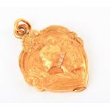 A yellow metal and diamond pendant in the Art Nouveau style decorated with a fine lady, wearing a