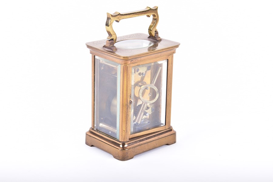 A brass bound Carriage clock with engraved inscription and enameled dial. - Image 2 of 4
