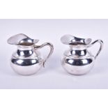A pair of Continental silver water jugs of bulbous form, impressed stamps to base, 14.5 cm high,