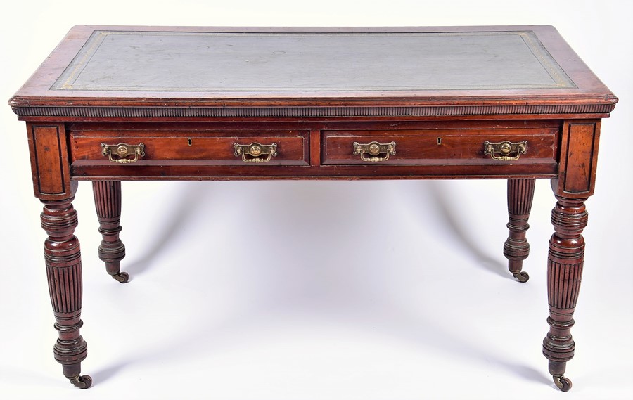 A Victorian mahogany library table with tooled green leather top over two frieze drawers and