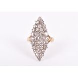 A yellow metal and diamond cluster ring the navette mount set with fifteen old-cut diamonds of