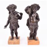 A pair of early 19th century bronze statuettes of putti mounted on marble bases, 22 cm high. (2)