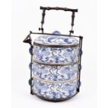 A Chinese Republic blue and white porcelain three tier rice caddy with metal mounts, decorated