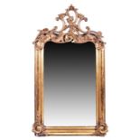 An 18th century gilt gesso framed wall mirror surmounted by scroll motifs, with probably the