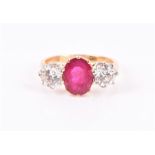 An 18ct yellow gold, diamond, and ruby ring set with an oval-cut ruby of approximately 2.30