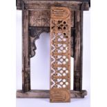 A large Indian carved window frame with scalloped interior edge, carved with stylised floral motifs,