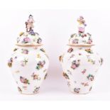 A pair of late 19th century Meissen style lidded urns of baluster form with encrusted floral details