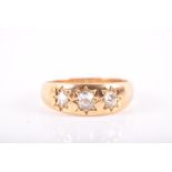 A yellow metal and diamond ring inset with three old-cut diamonds, unmarked shank, size Q 1/2, 5.5